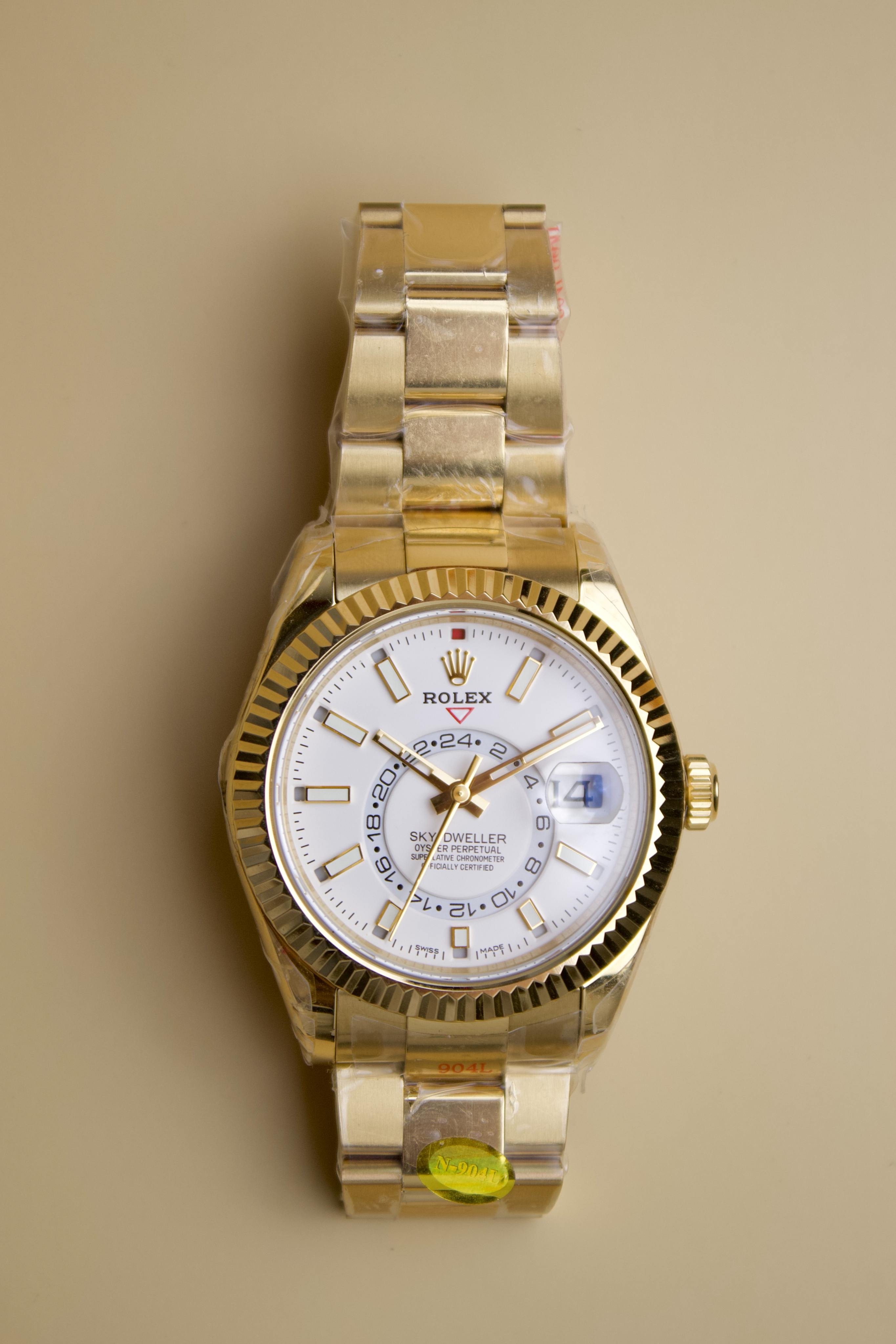 ROLEX SKY DWELLER. YELLOW GOLD & WHITE DAIL
